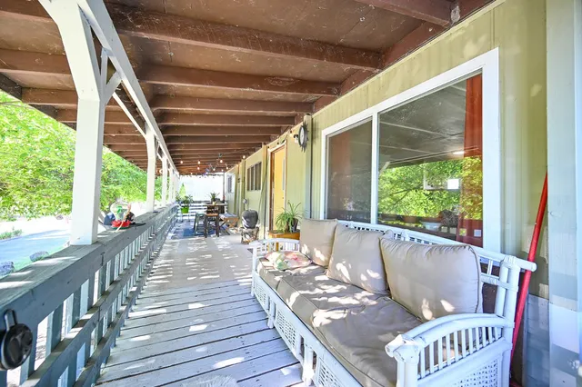 a view of a house with a backyard and a tree