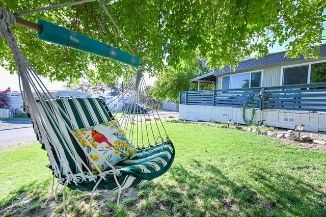 a view of a backyard with a patio and wooden fence