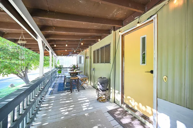 a view of a chairs and table in the backyard