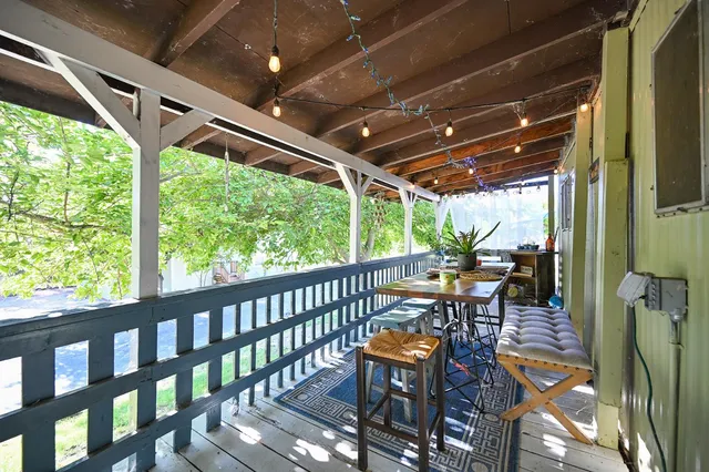 a view of a chair and tables in the backyard of house