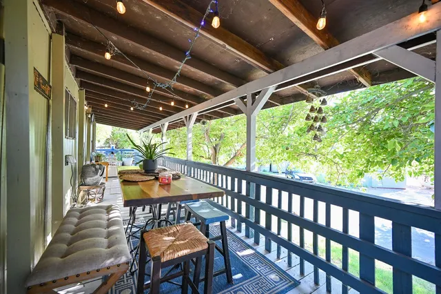 a view of a house with backyard and sitting area