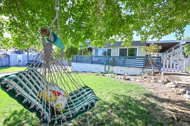 a backyard of a house with barbeque oven fire pit table and chairs