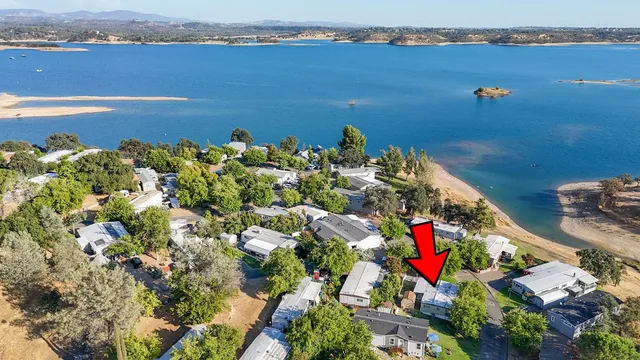 a view of a livingroom with wooden floor and a large window