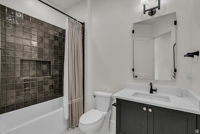 2608 Canyon Ridge Drive St. George, UT 84770 - Photo 66 of 86 Bathroom featuring a dark tiled tub/shower combination with an integrated niche, a white vanity with an undermount sink and matte black faucet, a framed mirror, and hexagonal floor tiling