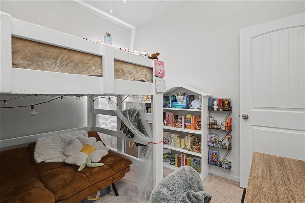 213 Sycamore Drive Calhoun, GA 30701 - Photo 22 of 44 a living room with furniture and a book shelf