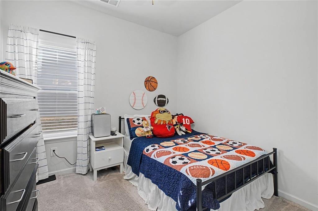 213 Sycamore Drive Calhoun, GA 30701 - Photo 23 of 44 a bedroom with a bed and window