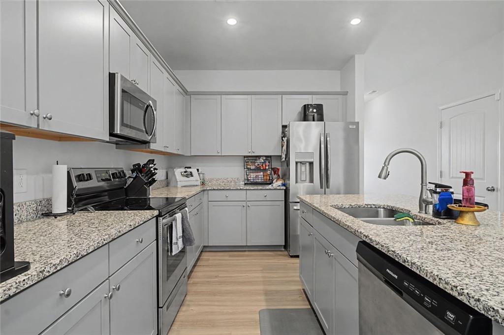 213 Sycamore Drive Calhoun, GA 30701 - Photo 9 of 44 a kitchen with granite countertop stainless steel appliances and sink