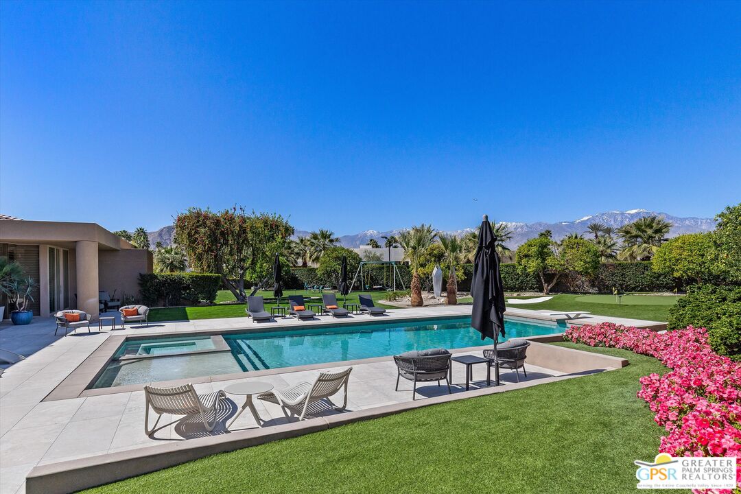 4 Big Sioux Road Rancho Mirage, CA 92270 - Photo 17 of 75 a view of a swimming pool with a patio and a yard