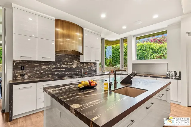 a bathroom with a granite countertop sink and a mirror