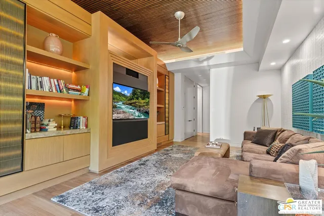 a bedroom with furniture and large windows