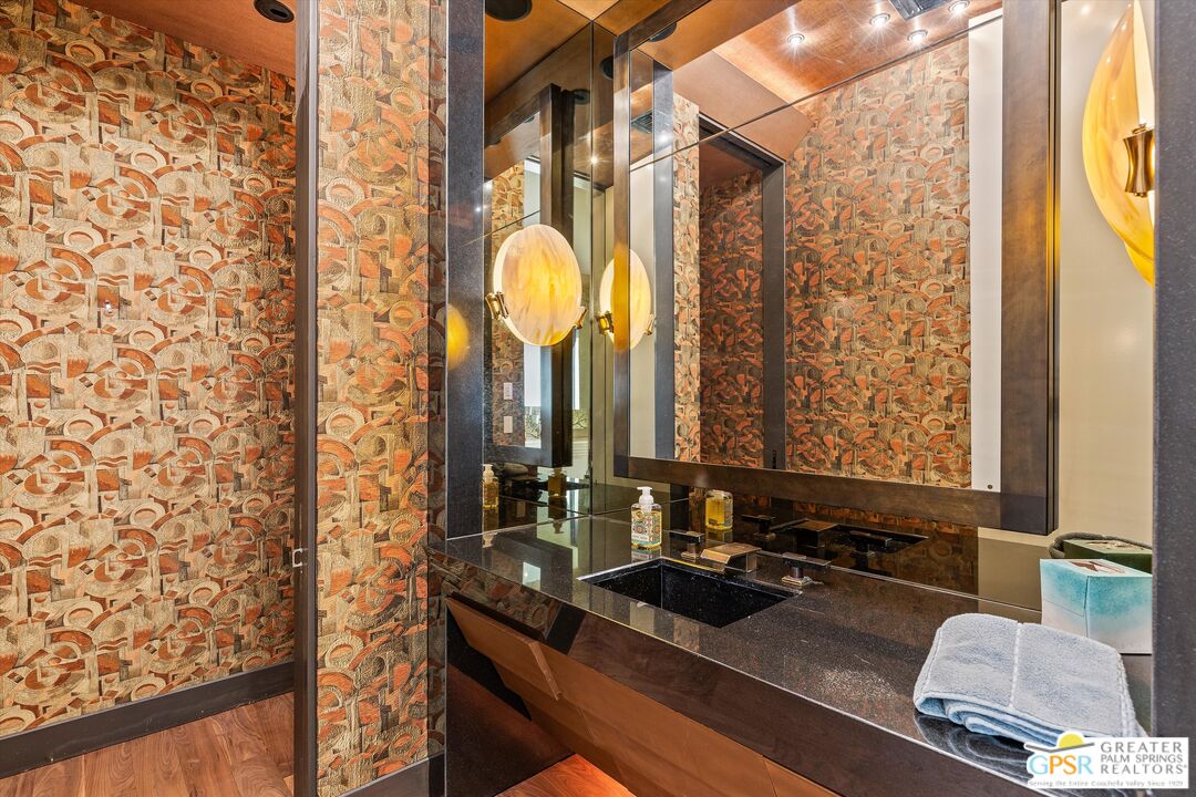 4 Big Sioux Road Rancho Mirage, CA 92270 - Photo 36 of 75 a bathroom with a granite countertop sink and a mirror