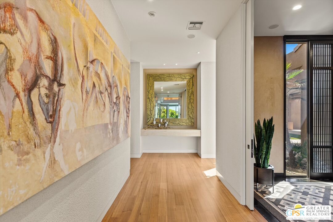 4 Big Sioux Road Rancho Mirage, CA 92270 - Photo 38 of 75 a view of a hallway with wooden floor and a bathroom