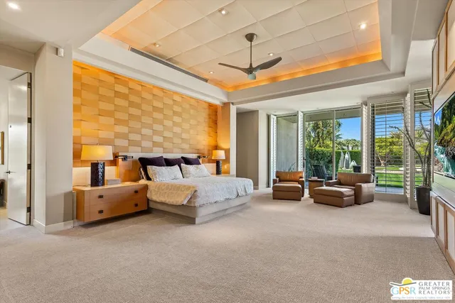 a bedroom with two beds and a large window