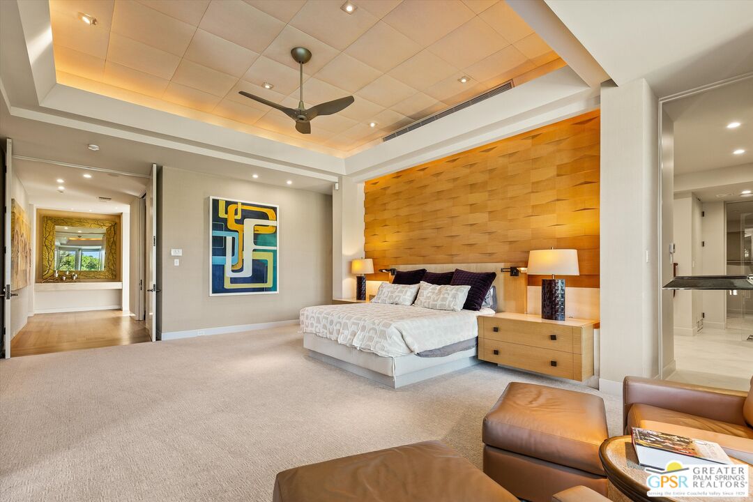 4 Big Sioux Road Rancho Mirage, CA 92270 - Photo 40 of 75 a spacious bedroom with a large bed and a chandelier