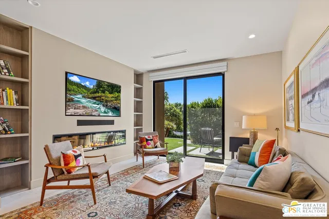 a view of a house with swimming pool and sitting area
