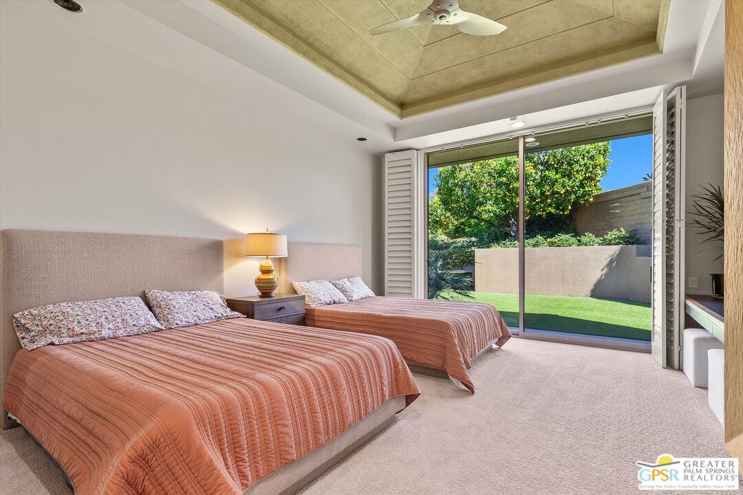 4 Big Sioux Road Rancho Mirage, CA 92270 - Photo 52 of 75 a bedroom with two beds and a large window