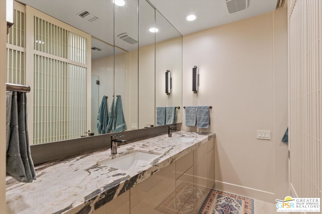 4 Big Sioux Road Rancho Mirage, CA 92270 - Photo 53 of 75 a bathroom with a granite countertop sink a mirror and shower