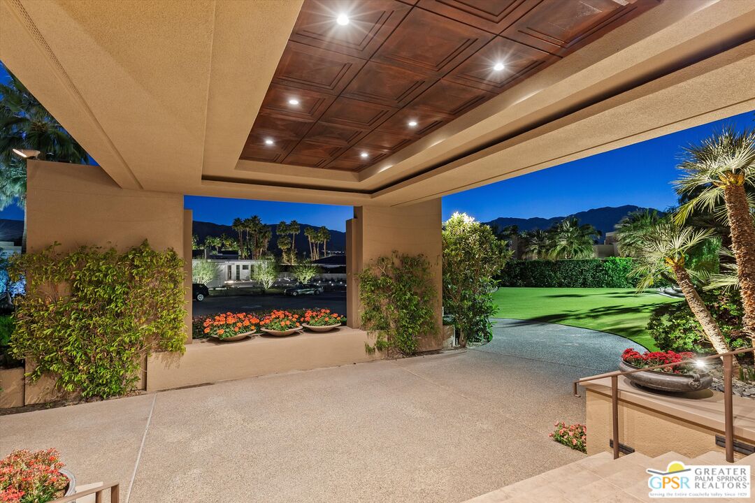 4 Big Sioux Road Rancho Mirage, CA 92270 - Photo 72 of 75 a view of a patio with table and chairs under an umbrella