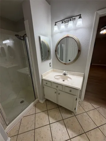 a bathroom with a sink a mirror and bathtub