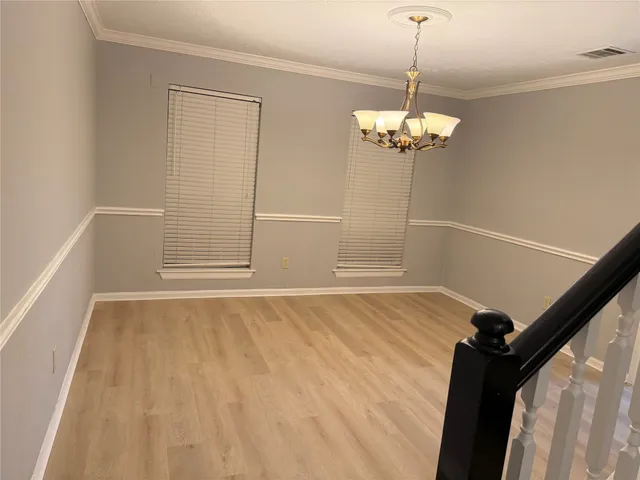 a view of a room with a window and wooden floor