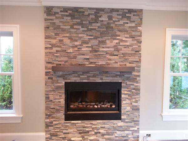 Lot 116 The Ridge Newton, MA 02459 - Photo 4 of 9 a stone fireplace with a clock on it