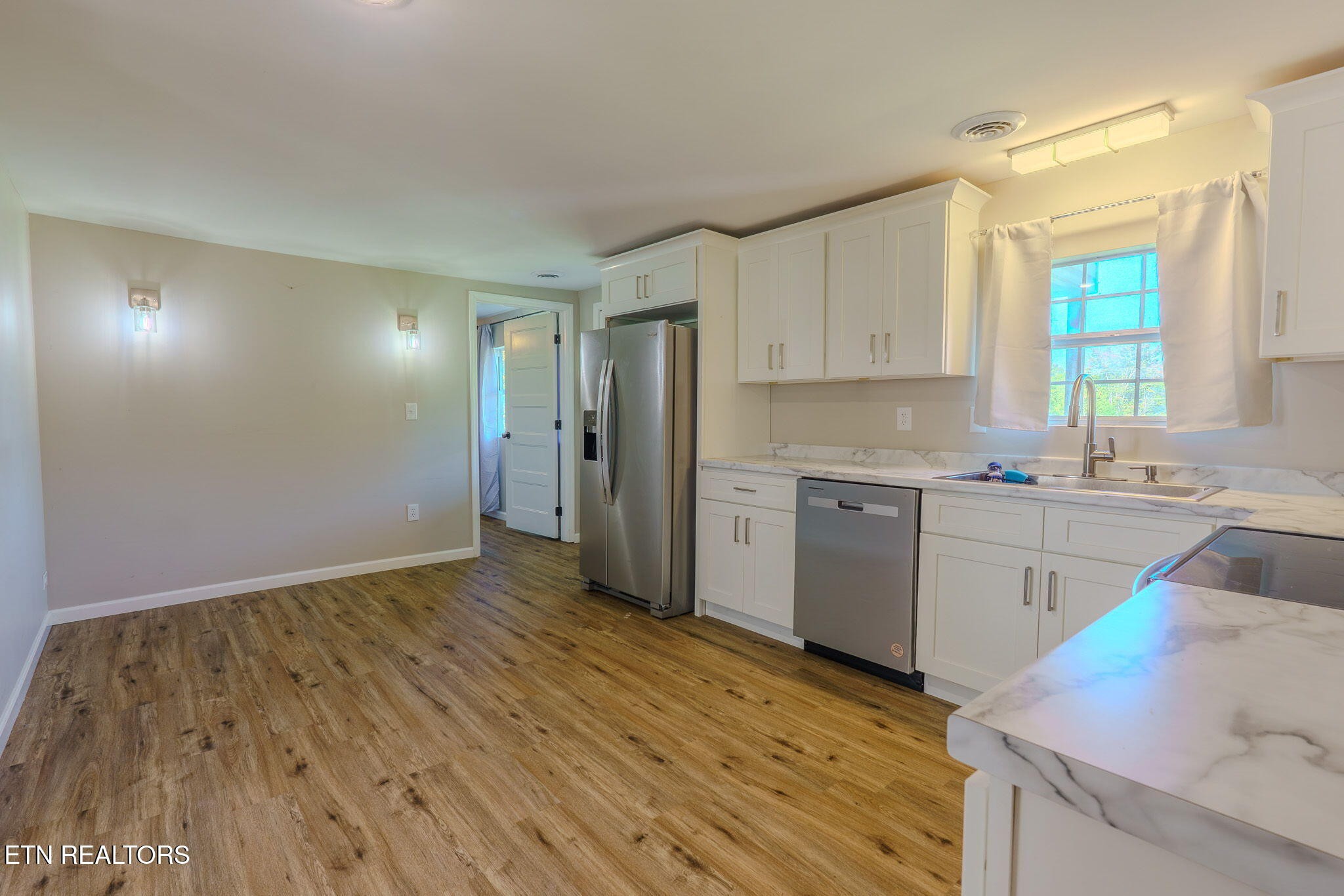 2331 Webb Road Sevierville, TN 37876 - Photo 14 of 23 a view of a kitchen with wooden floor and electronic appliances