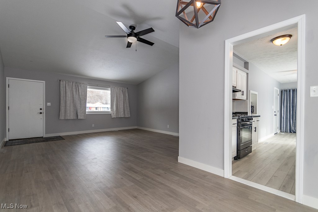7996 Munson Road Mentor, OH 44060 - Photo 2 of 33 Unfurnished living room featuring hardwood / wood-style floors and ceiling fan