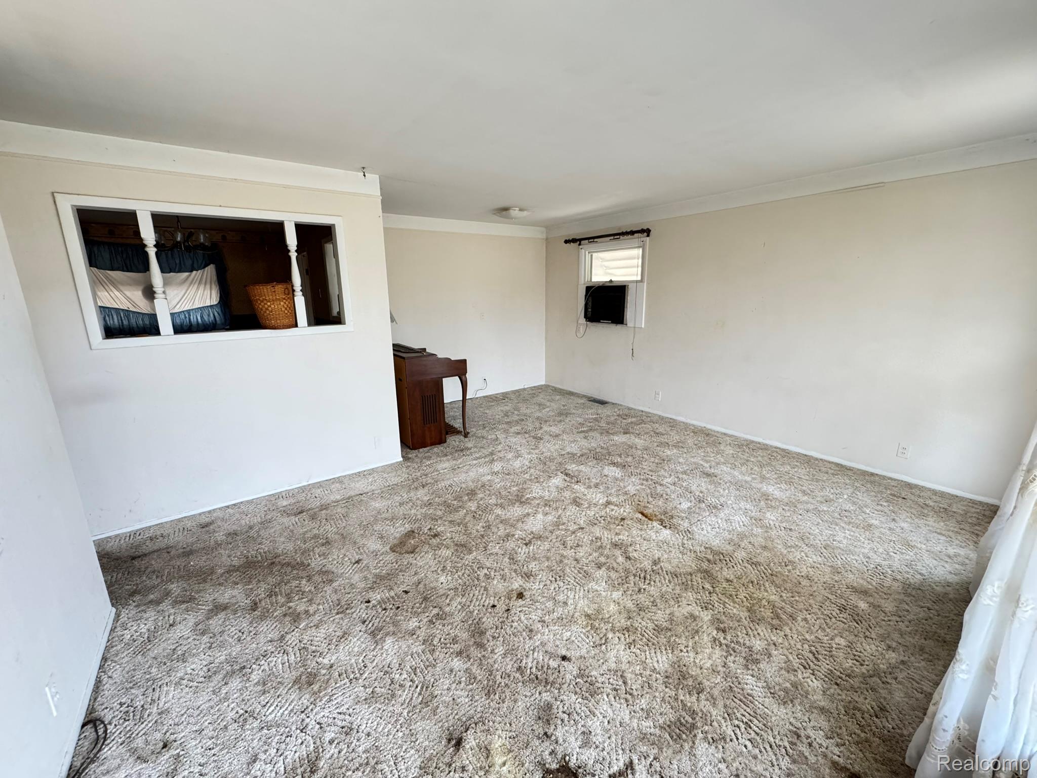 47166 Roland Street Utica, MI 48317 - Photo 9 of 18 Carpeted spare room with ornamental molding