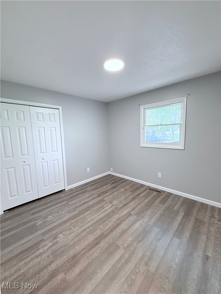 4816 Wake Robin Road Mentor, OH 44060 - Photo 14 of 19 Unfurnished bedroom with wood finished floors, baseboards, and a closet