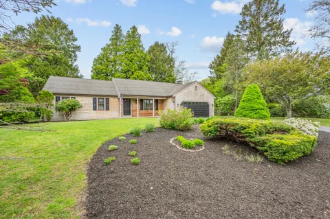 a front view of a house with garden