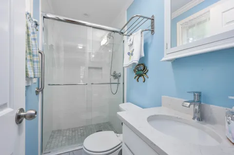 a bathroom with a sink toilet and shower