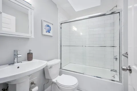 a bathroom with a sink toilet and shower