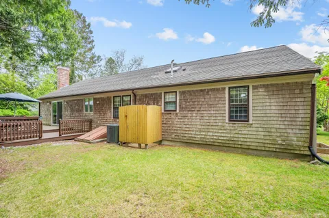 a view of a house with backyard porch and sitting area
