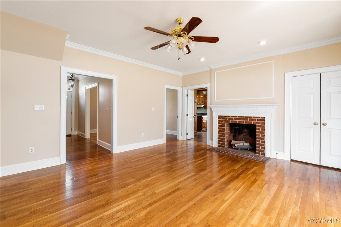 207 Comstock Drive Colonial Heights, VA 23834 - Photo 11 of 44 a view of an empty room with wooden floor a fireplace and a window