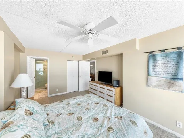 a bedroom with furniture and a large window