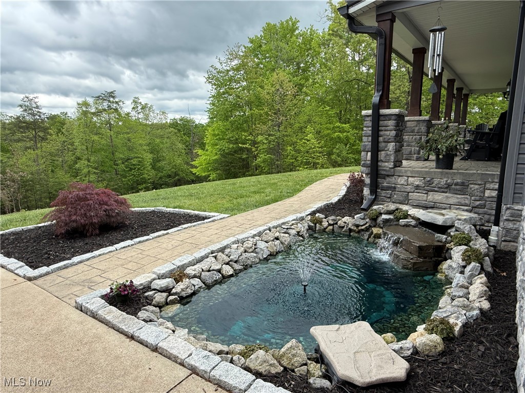 399 Wilder Road Vinton, OH 45686 - Photo 34 of 36 View of grassy yard featuring a small pond and a patio