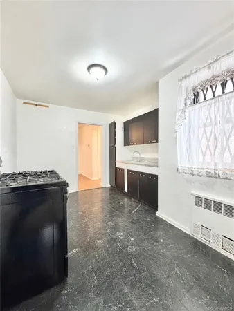 a view of an empty room with a fireplace and a window