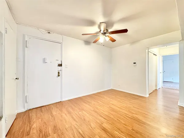 a view of empty room with wooden floor