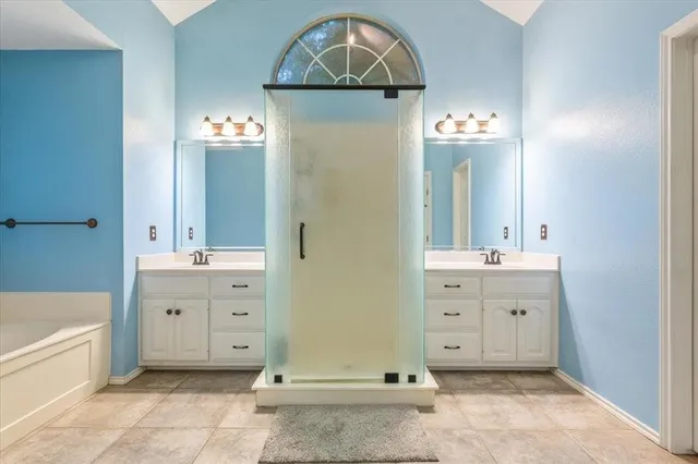 a living room with a bed furniture and paintings on the wall