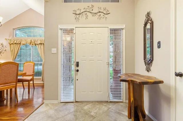 a dining room with furniture a chandelier and wooden floor