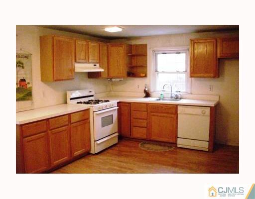 0 Freehold Road Manalapan, NJ 07726 - Photo 4 of 10 a kitchen with a sink window and cabinets