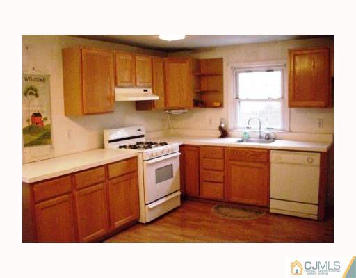 0 Freehold Road Manalapan, NJ 07726 - Photo 5 of 10 a kitchen with a sink window and cabinets