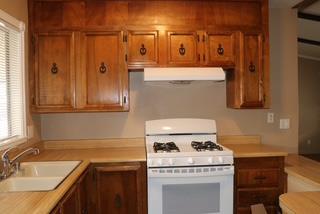 15820 South Harlan Road, Unit 143 Lathrop, CA 95330 - Photo 12 of 40 a kitchen with a stove and a sink
