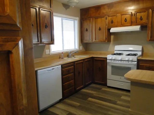 a kitchen with a stove a sink and a microwave