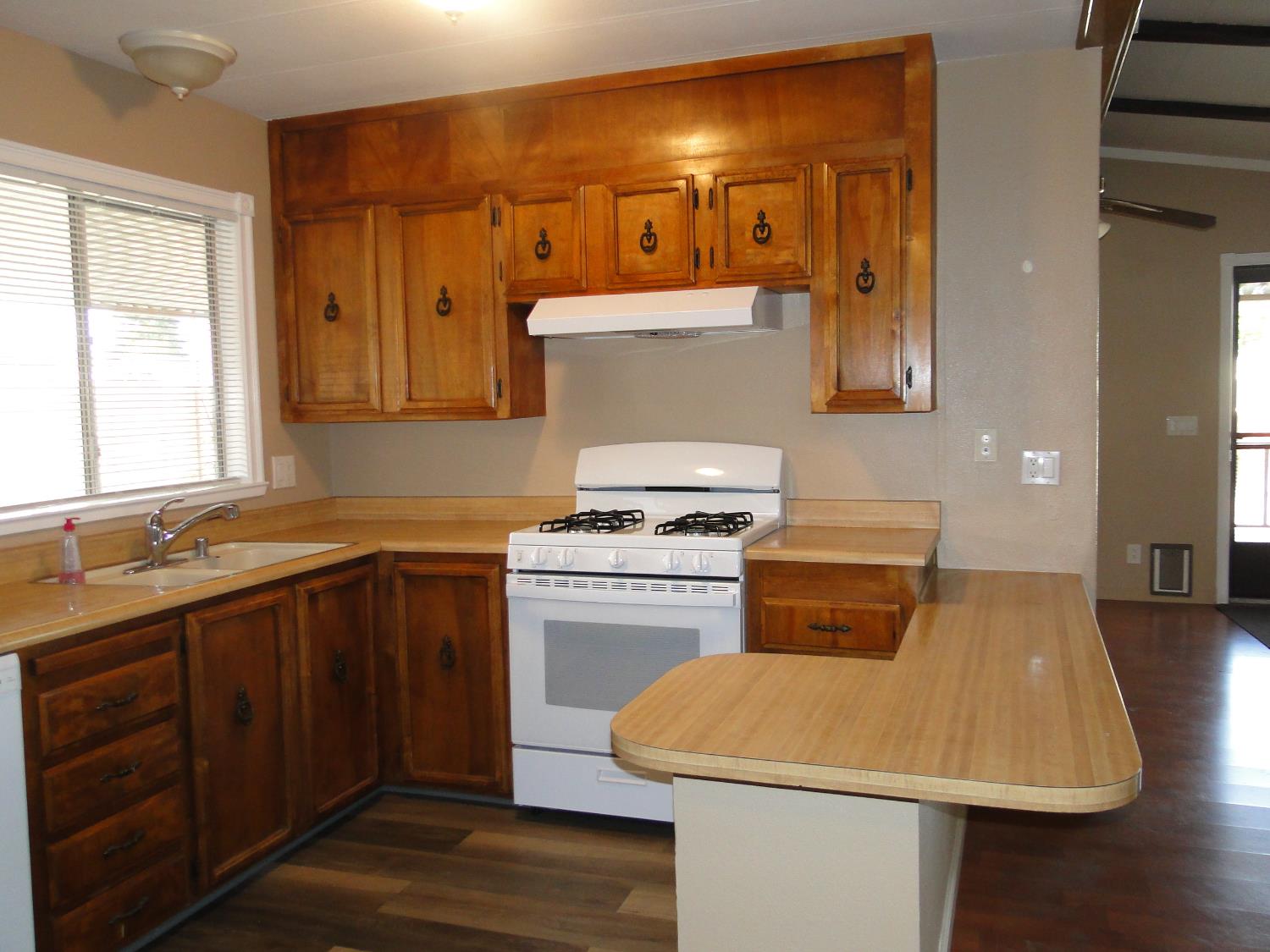 15820 South Harlan Road, Unit 143 Lathrop, CA 95330 - Photo 14 of 40 a kitchen that has a sink and a stove in it
