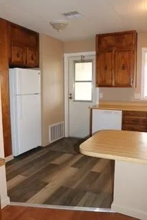 a kitchen with refrigerator and sink