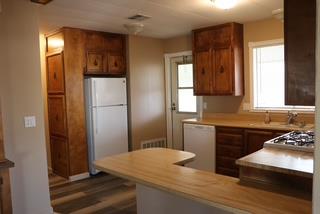 15820 South Harlan Road, Unit 143 Lathrop, CA 95330 - Photo 18 of 40 a kitchen with a refrigerator and a stove top oven