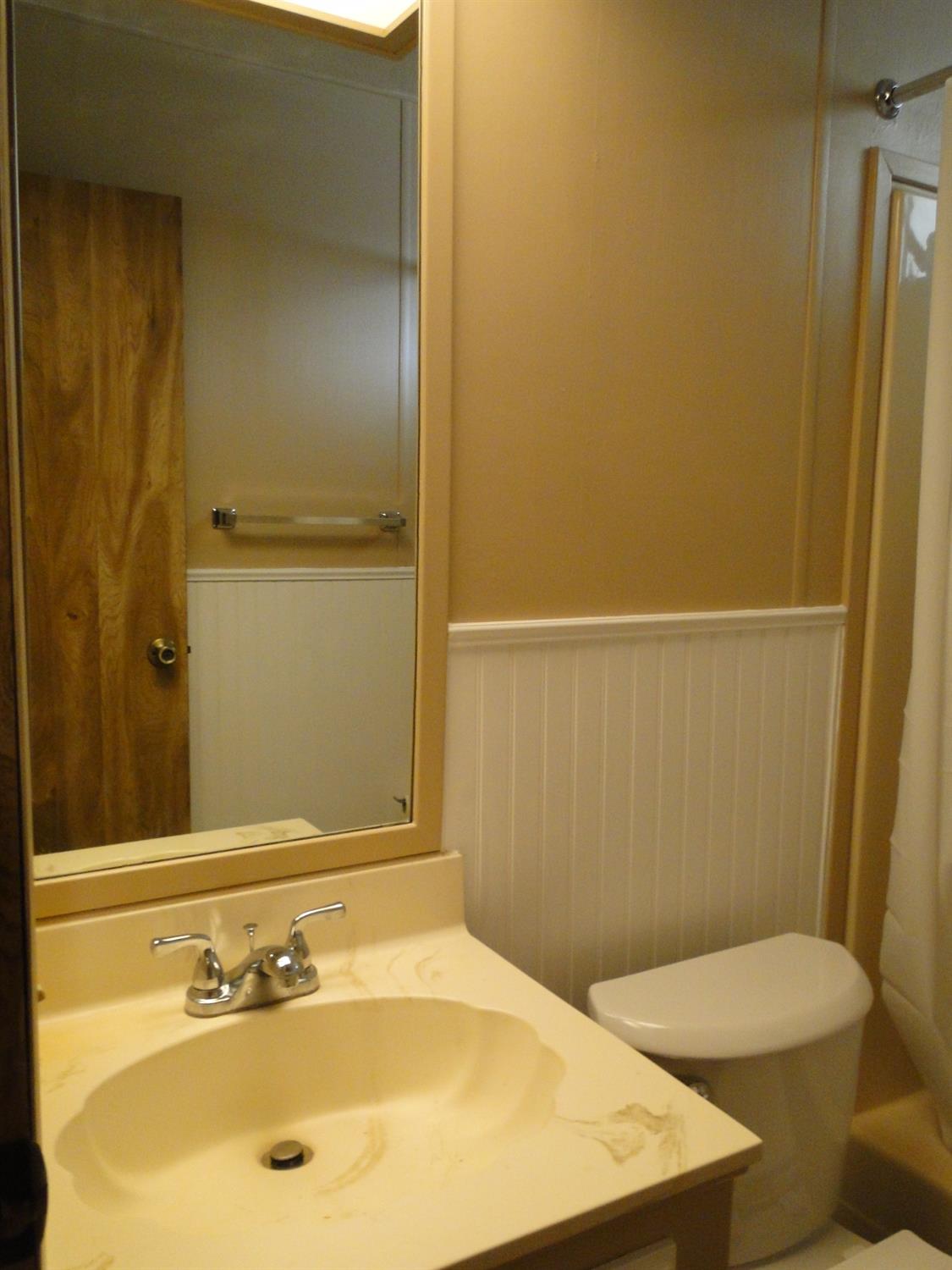 15820 South Harlan Road, Unit 143 Lathrop, CA 95330 - Photo 29 of 40 a bathroom with a sink and a mirror