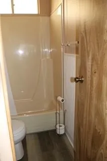 a view of wooden floor and a window in a room