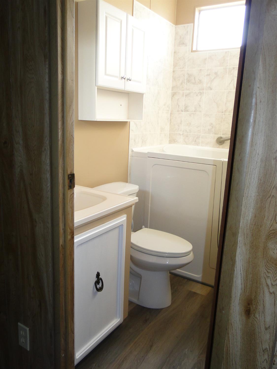 15820 South Harlan Road, Unit 143 Lathrop, CA 95330 - Photo 38 of 40 a white toilet sitting next to a bathroom sink